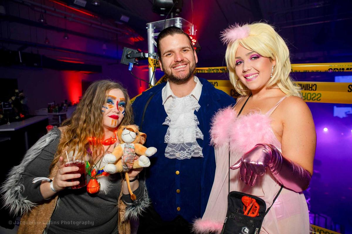 Adults in creative Halloween costumes at Coloween, the Denver Halloween Party