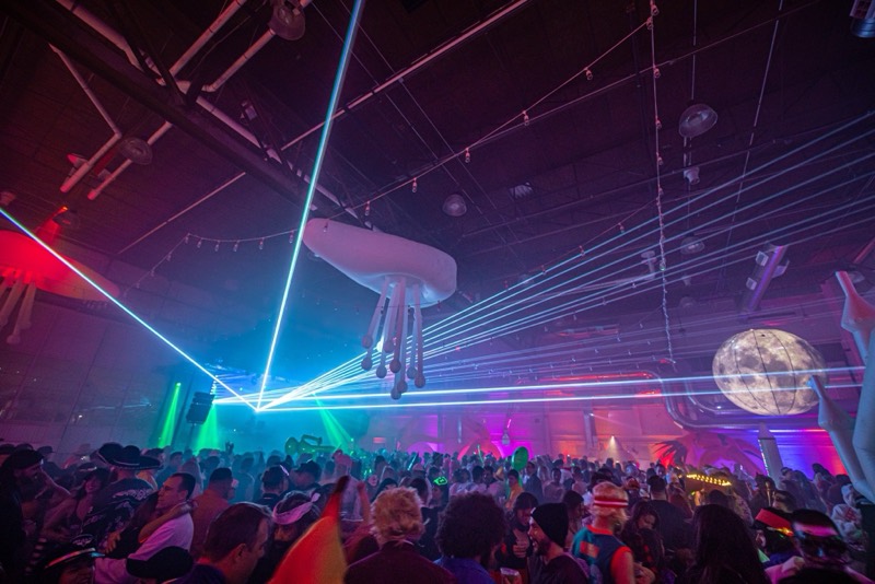 Lasers, a glowing moon, and floating jellyfish over the packed dancefloor at the Coloween costume contest in Denver