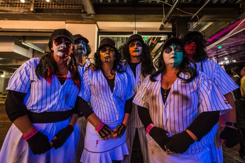Baseball gang in skull face paint lines up for the camera at the Coloween costume contest in Denver