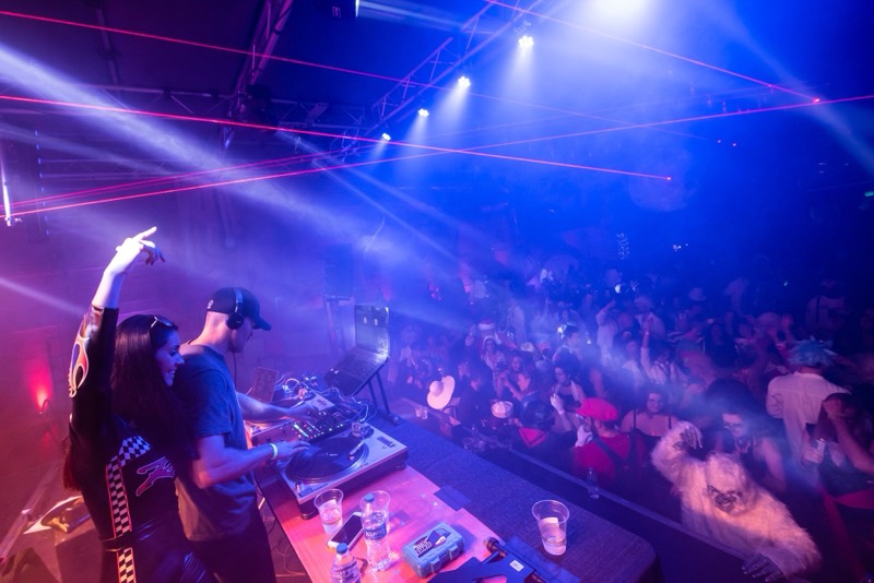 DJs spin over a costumed crowd as red lasers cut the fog at Coloween — Denver Halloween nightlife