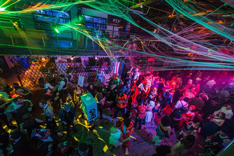 Overhead view of the dancefloor, cobwebs, and one dancing BMO at Coloween, Denver's 21+ Halloween party