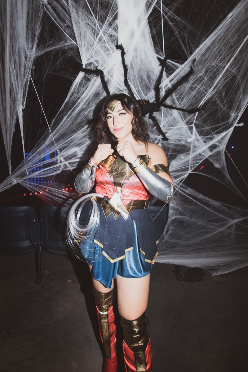 Wonder Woman squares up with her lasso by the giant spider at Denver's Coloween Halloween party