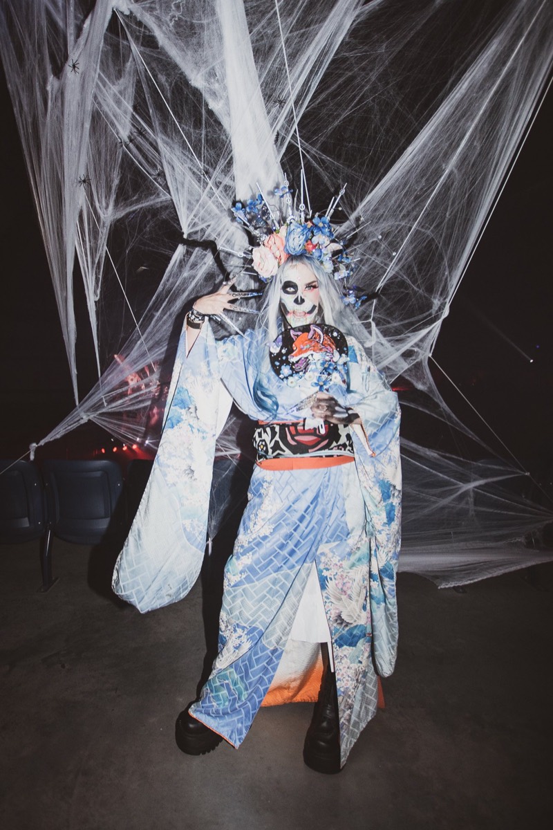 Skull-painted geisha in a blue kimono with a spiked flower crown at Colorado's biggest adult Halloween party