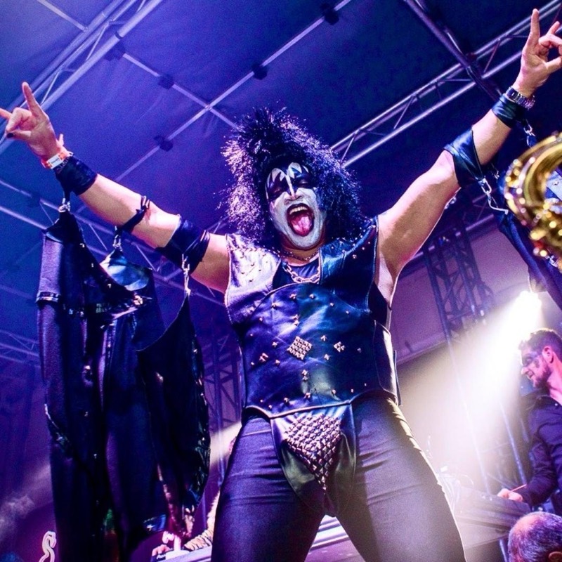 Studded leather and full face paint, tongue out over the crowd at Coloween, Denver's 21+ Halloween party