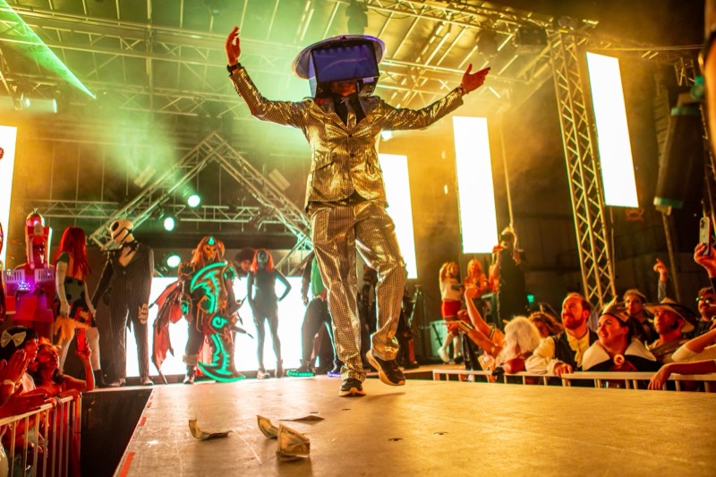 Mirror-ball suit with a TV head struts the contest runway at the Coloween costume contest in Denver