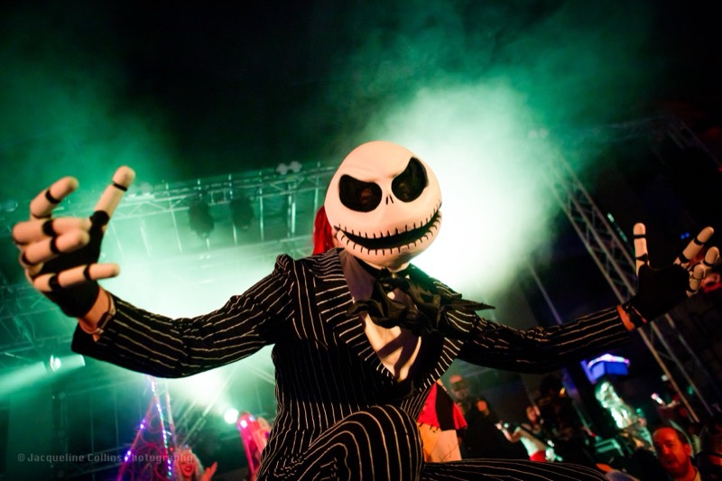 Jack Skellington looms over the crowd in green stage fog at Denver's Coloween Halloween party