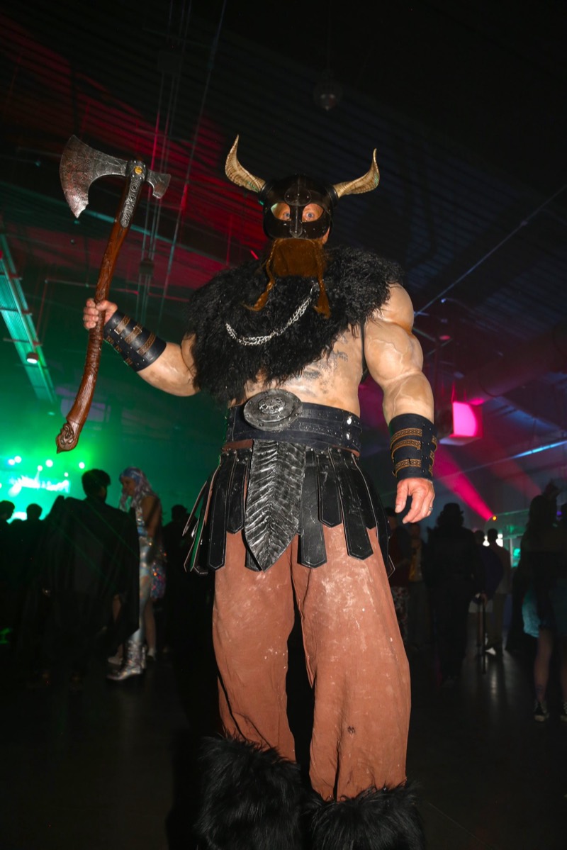 Horned viking with axe and fur boots towers over the floor at Denver's Coloween Halloween party