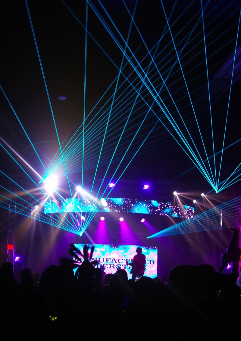 Blue lasers fan out over a silhouetted main-stage crowd at Coloween 2024 in Colorado