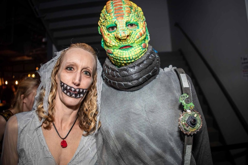 Ghoulish bride beside a lizard-scaled face with circuit-board shoulder gear at Colorado's biggest adult Halloween party