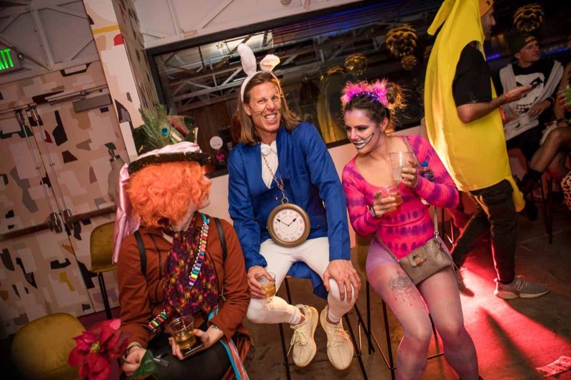 Rabbit, Cheshire cat, and Hatter share drinks between dances at the Coloween costume contest in Denver