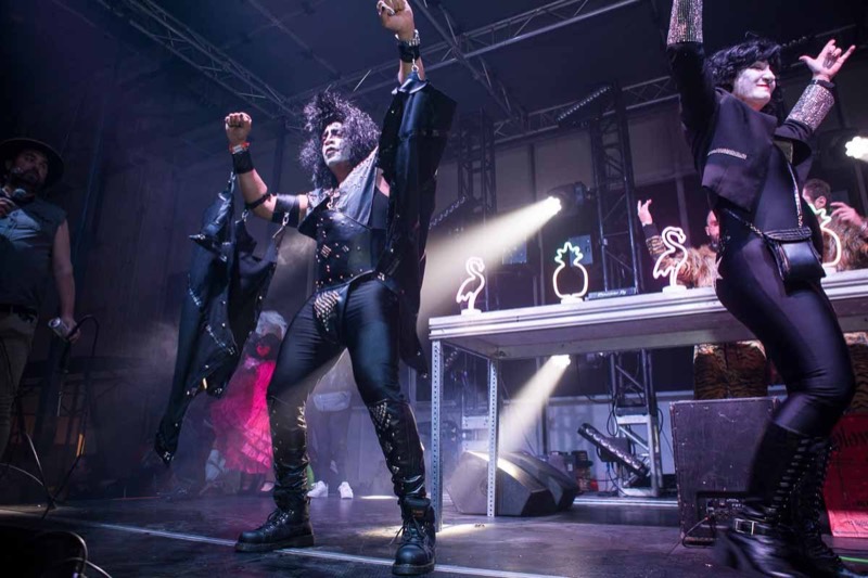 Face-painted rockers in studded leather work the stage lights at Coloween 2025 in Colorado