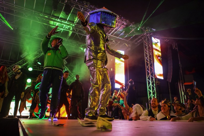 Mirror-suited dancer with a disco box head works the stage at Coloween — Denver Halloween nightlife