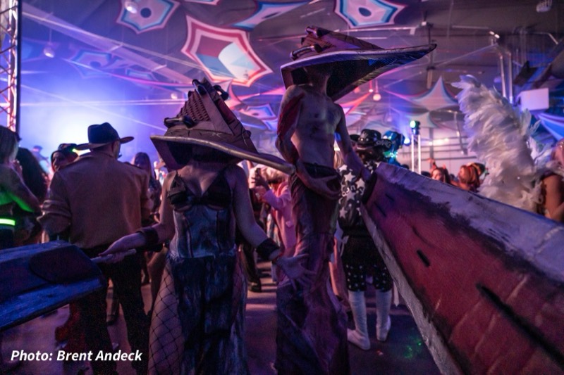 Two pyramid-headed horrors drag a giant blade through the crowd at Colorado's biggest adult Halloween party