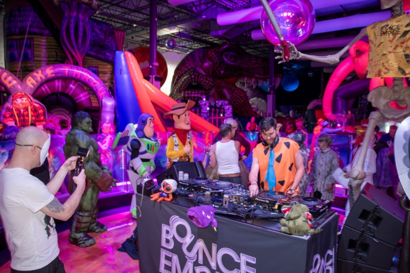 Fred Flintstone on the decks with the Hulk, skeletons, and a pink octopus at the adults-only Coloween Halloween event