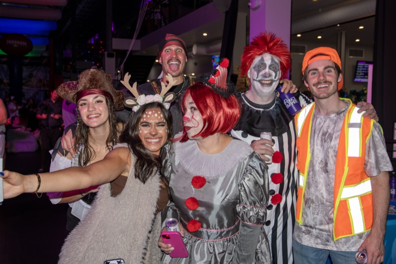 Six friends squeeze in: deer, Pennywise, and clowns mid-laugh at Coloween 2025 in Colorado