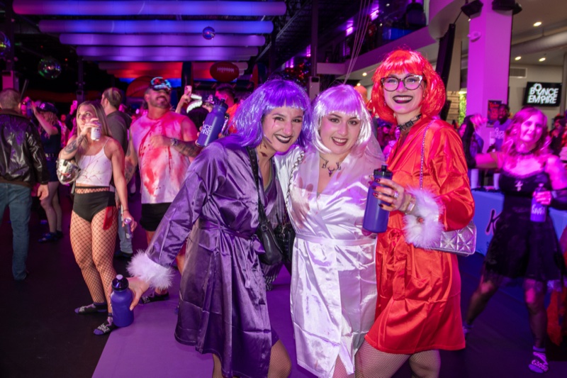 Purple, white, and orange wigs with matching satin robes at Coloween, Denver's 21+ Halloween party