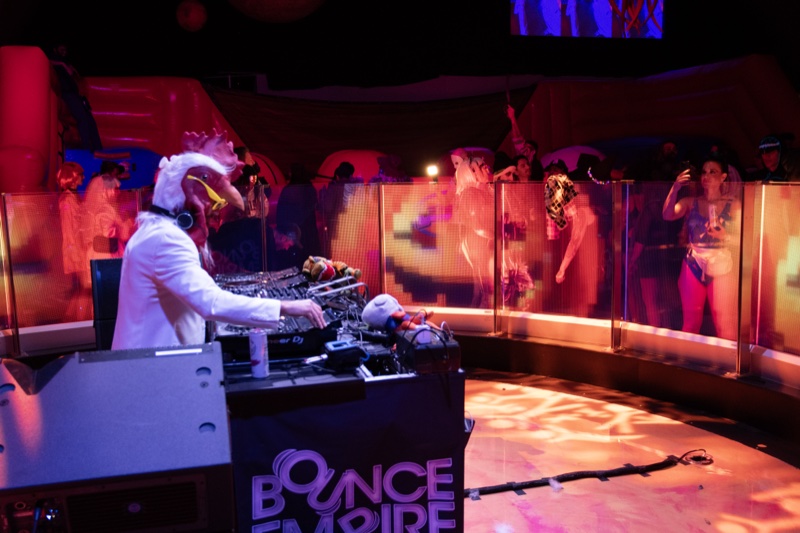 A chicken-headed DJ in a white suit runs the booth at Coloween — Denver Halloween nightlife